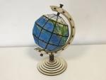 Earth globe with axis and rotating bracket in segment technology 